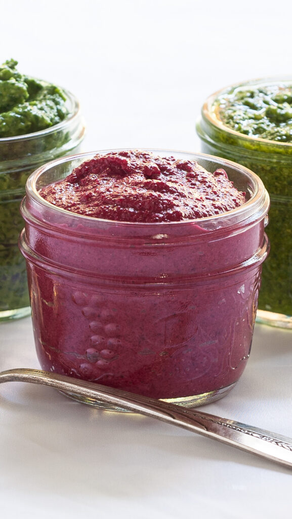 A photo of pink red beet pesto in a small mason jar.