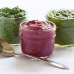 A photo of pink red beet pesto in a small mason jar.