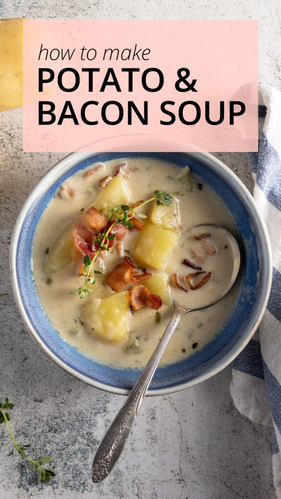 An overhead photo of a bowl of creamy potato and bacon soup, with a soup spoon, blue and white napkin, yellow potatoes, and bacon. A spring of thyme is the garnish on the soup.