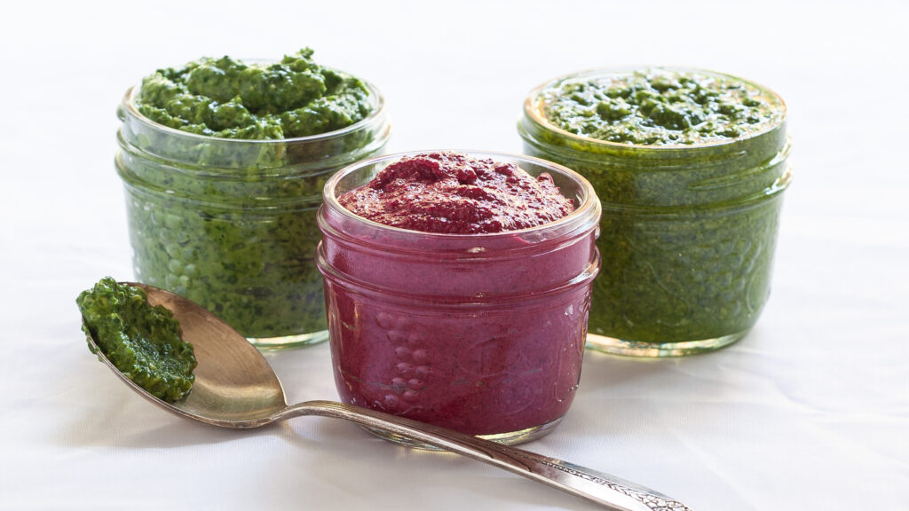 A photo of pink red beet pesto in a small mason jar.