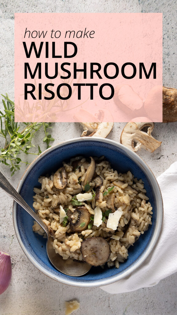 An overhead view of a bowl of wild mushroom risotto, with mushrooms, parmesan cheese, a shallot, fresh thyme and rosemary, and a white dinner napkin.