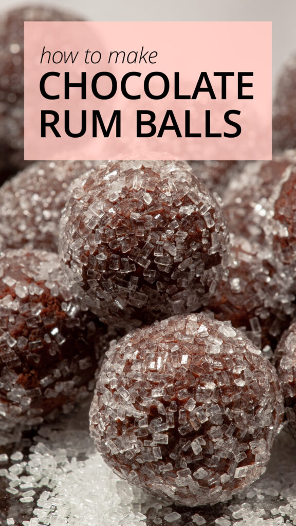 A pile of chocolate rum balls sits in a pile, on a mirrored surface.