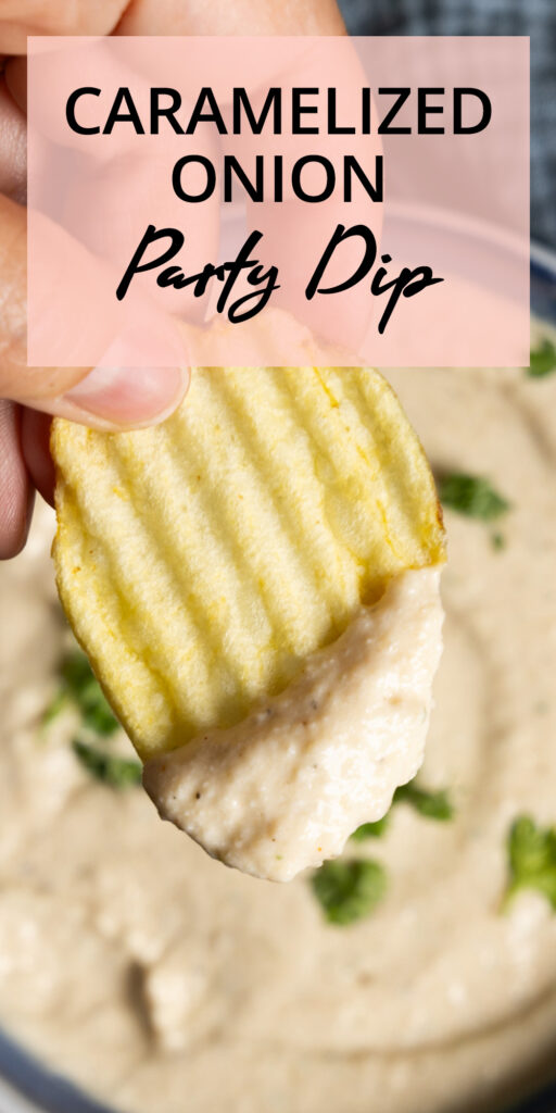 A bowl of onion dip sits on a counter with ripple potato chips on the side. A hand holding a ripple potato chip has scooped some dip onto the chip.