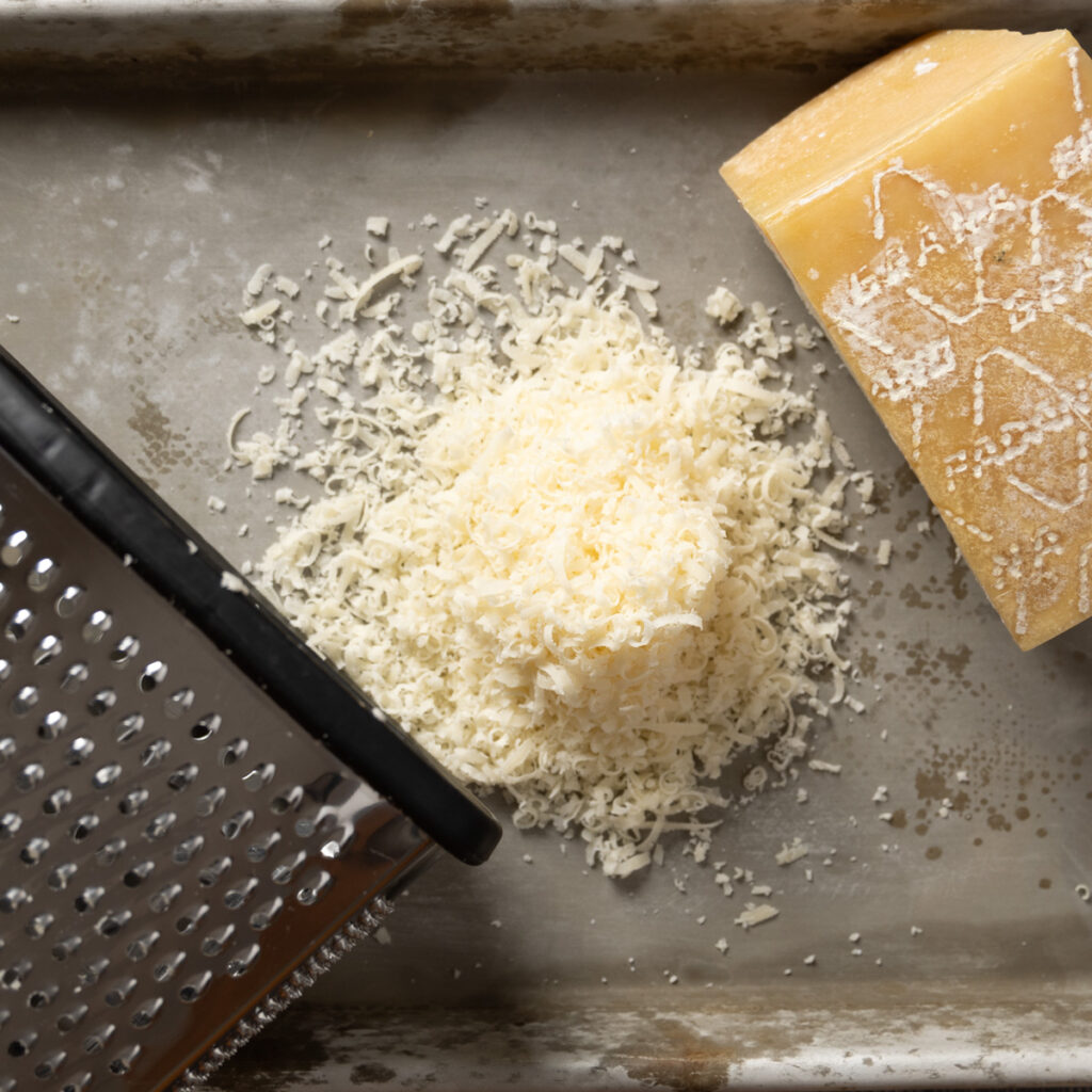 Grating parmesan cheese.