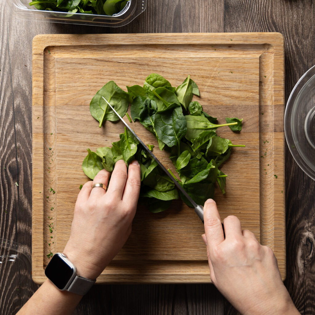 Chopping baby spinach.