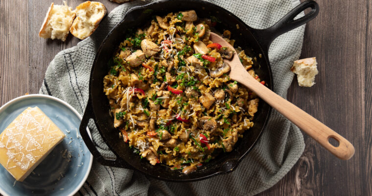 A skillet with a creamy chicken and mushroom pasta recipe.