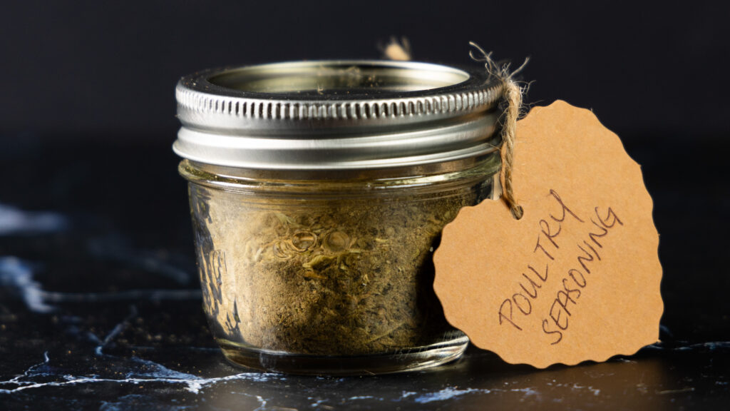 A jar of homemade Poultry Seasoning with a hand-made label.