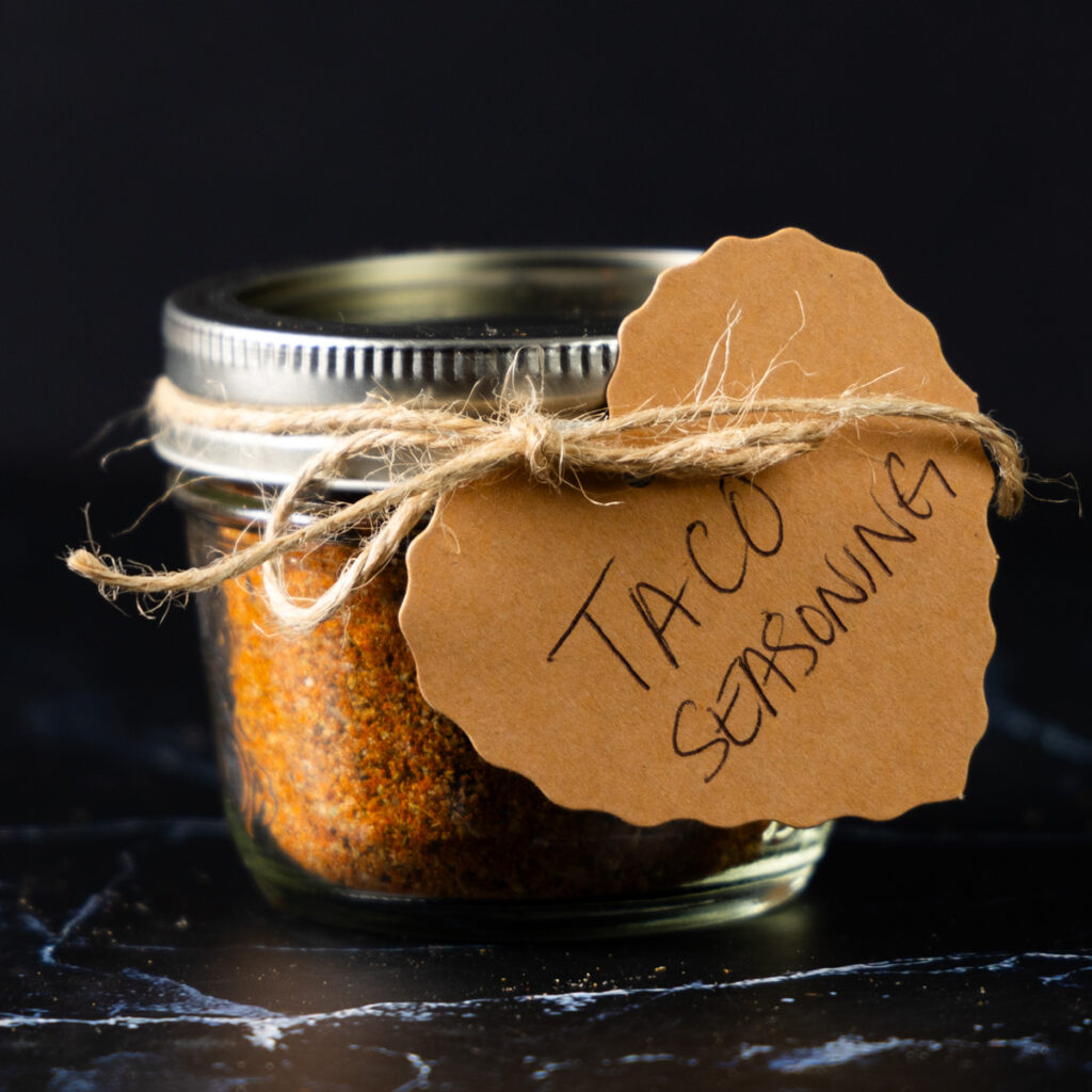 A jar of homemade Taco Seasoning with a hand-made label.
