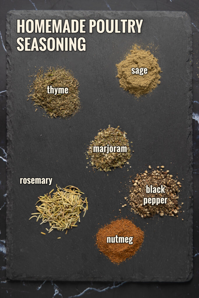 Ingredients to make Homemade Poultry Seasoning are arranged on a slate.
