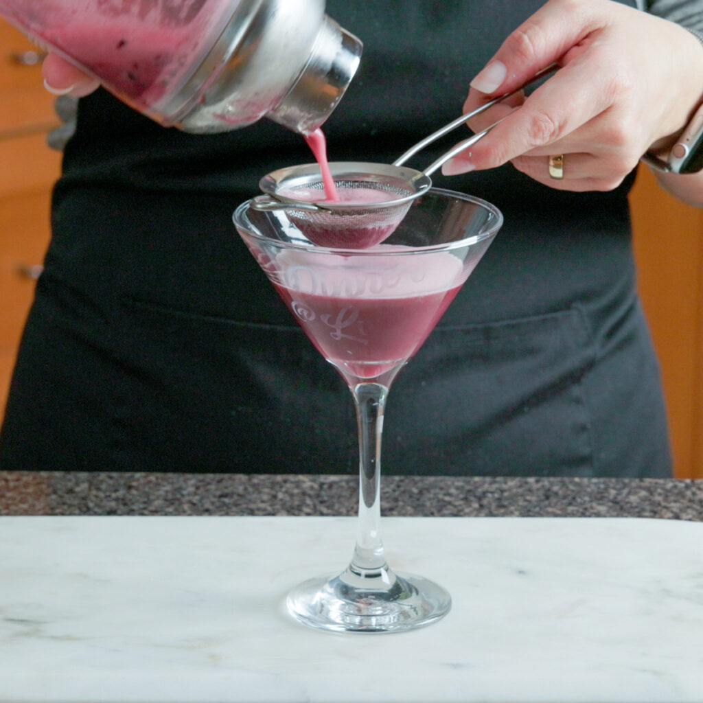 How to make a Blackberry Basil Sour: Double-strain into a cocktail glass.