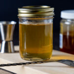 A mason jar contains Honey Simple Syrup