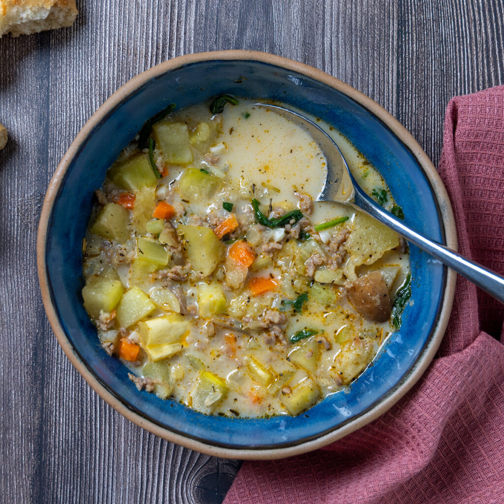 Rustic winter squash roasted with herbs and spices, combined with Italian sausage, potatoes, and spinach for a warm and cozy soup.