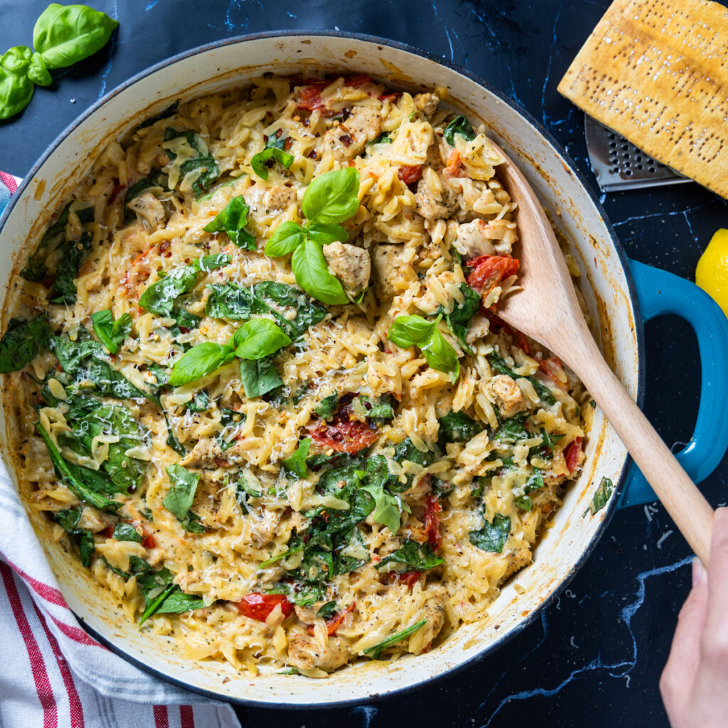 A skillet contains an orzo dish with a creamy sauce: One Pan Creamy Boursin Chicken Orzo