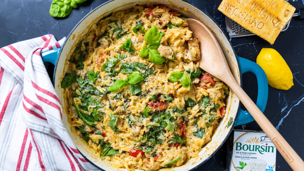 A skillet contains an orzo dish with a creamy sauce: One Pan Creamy Boursin Chicken Orzo