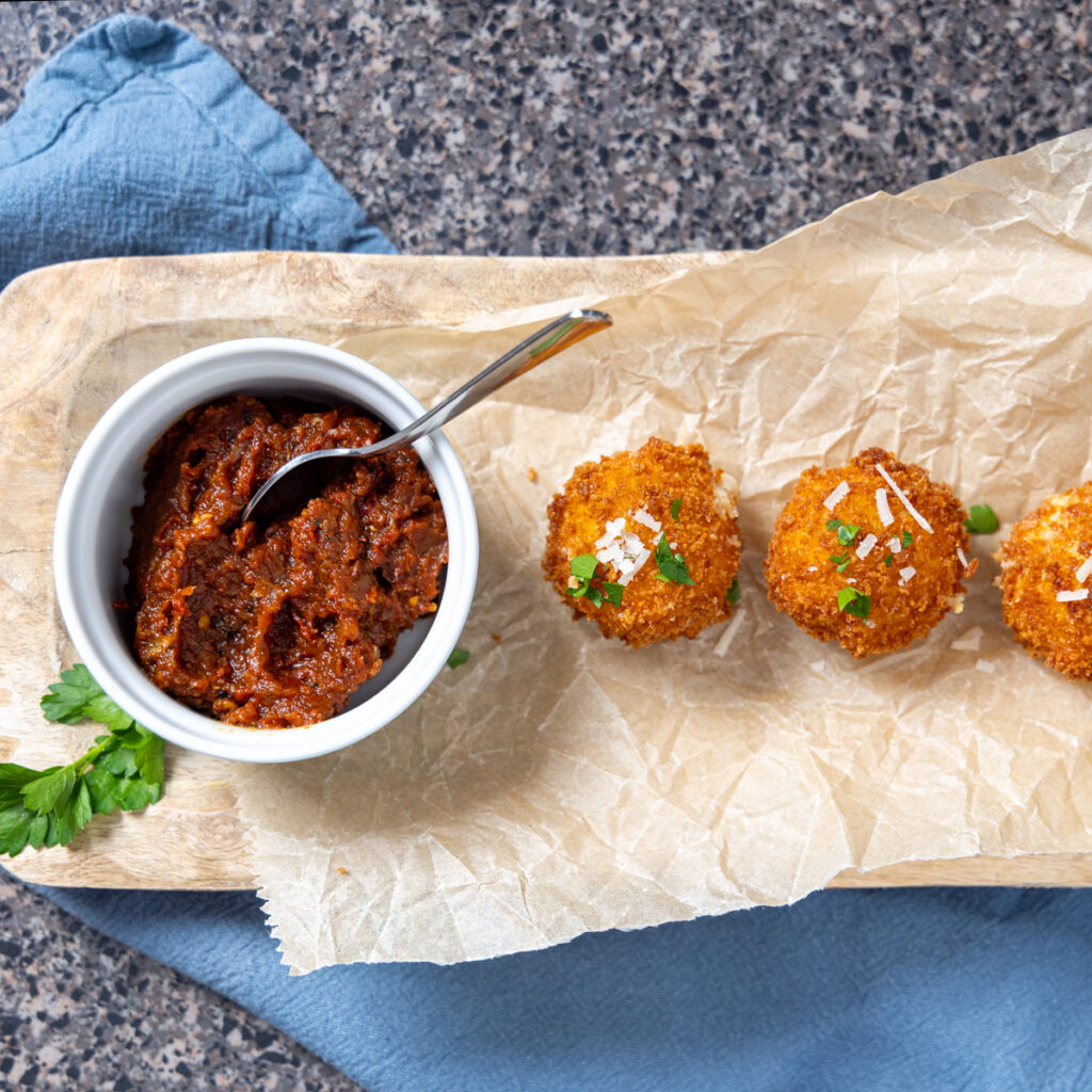 Roasted tomato sauce served with fried cheese balls