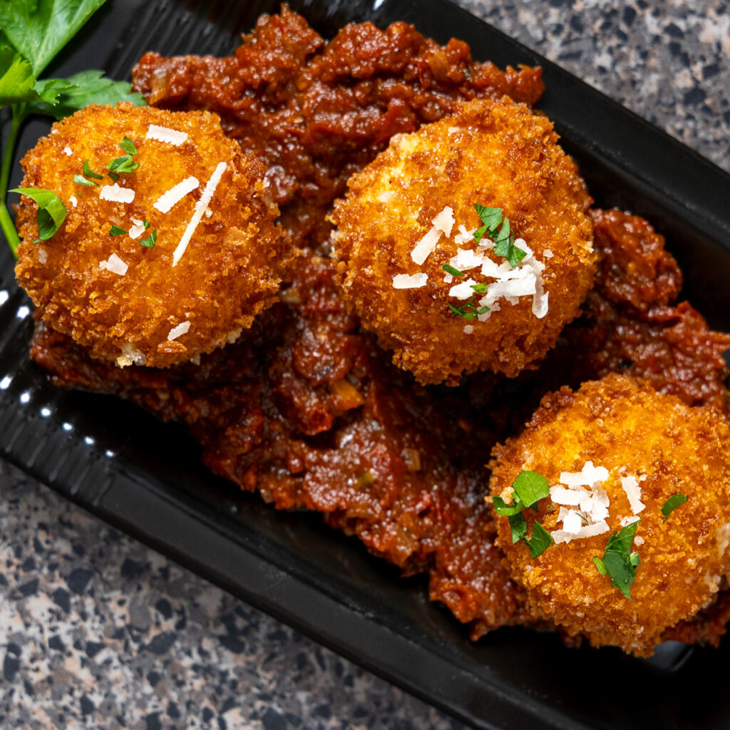 Roasted tomato sauce served with fried cheese balls